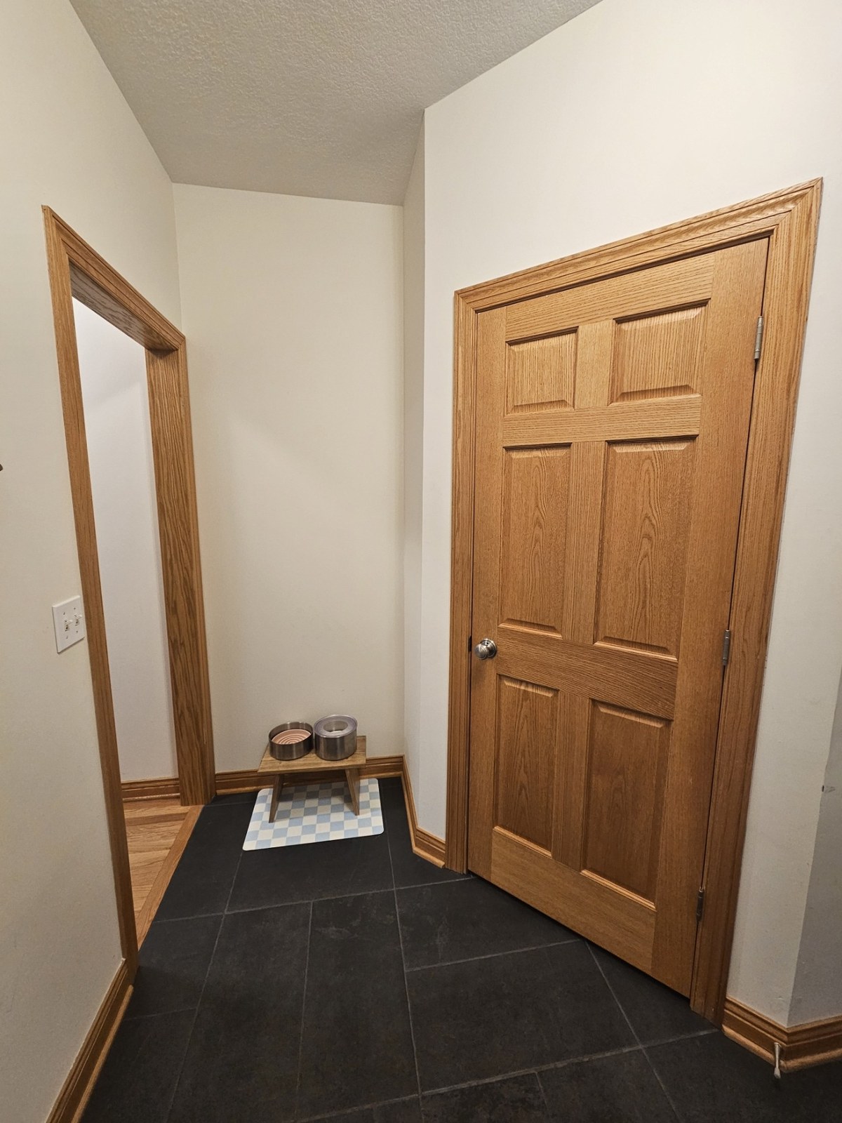 Hallway with finished interior door and matching trim